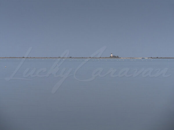 Gacholle lighthouse seen from the sea wall, Camargue, France