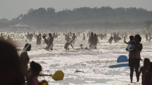 Vacationers on a beach in August, Occitania, southern France