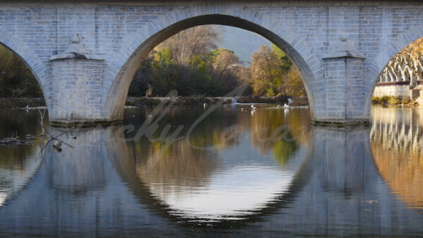 Old stone bridge, perfect circle in the river