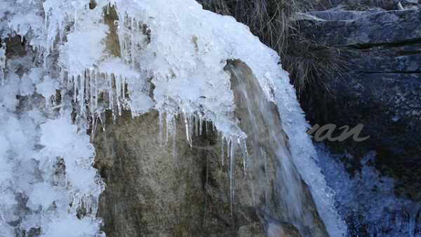 Ice melting in a small waterfall