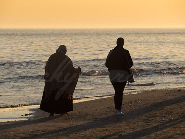 Muslim women strolling on the beach