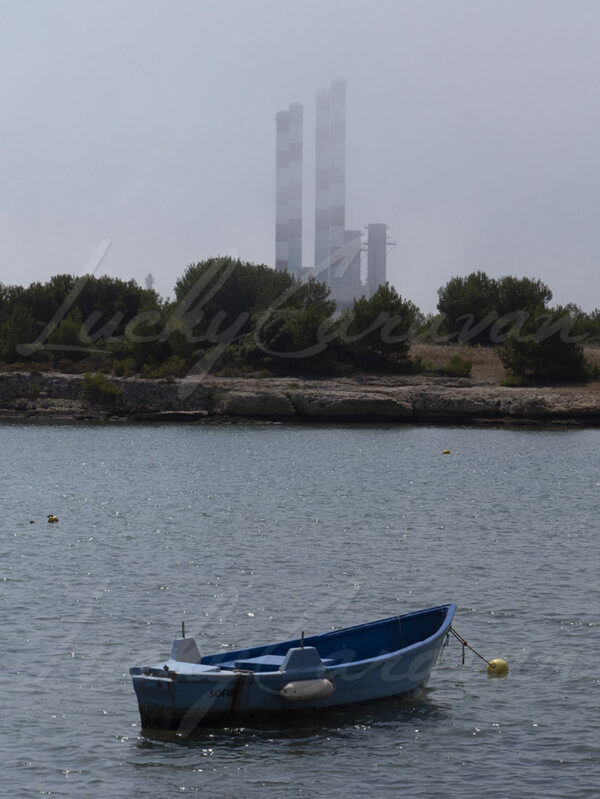 Boat moored in front of the EDF thermal power plant in Martigues, France.