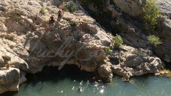 Young adolescents diving in the gorges of the Hérault River, southern France