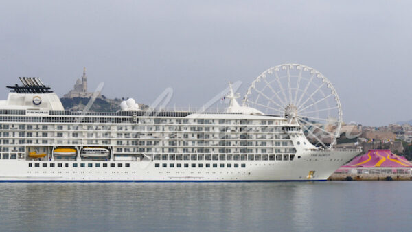 Seaport of Marseille with ocean liner, ferris wheel and Notre Dame de la Garde Basilica, southern France