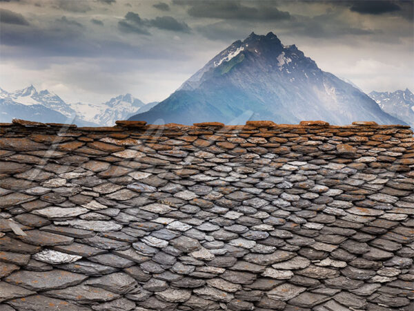 Stone roof in front of a mountain range in the Alps, Valle d'Aosta, Italy