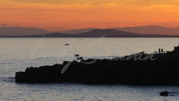 Jogging, boating and fishing on the mediterranean coast at sunset, southern France