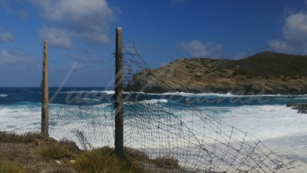 Strong winds and rough sea behind deteriorated fencing