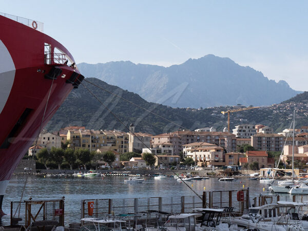 Sailors on a docked ferry look out over the surrounding landscape, Corsica, France