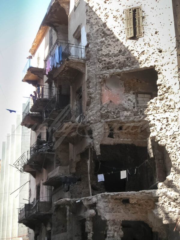 Inhabited bombed and bullet riddled building following the civil war in Lebanon, Beirut 2002