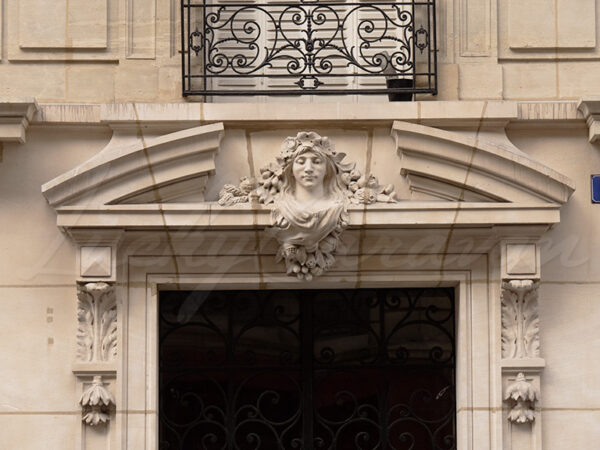 Mascaron above the entrance to a building, probably representing Fortuna, Paris, France