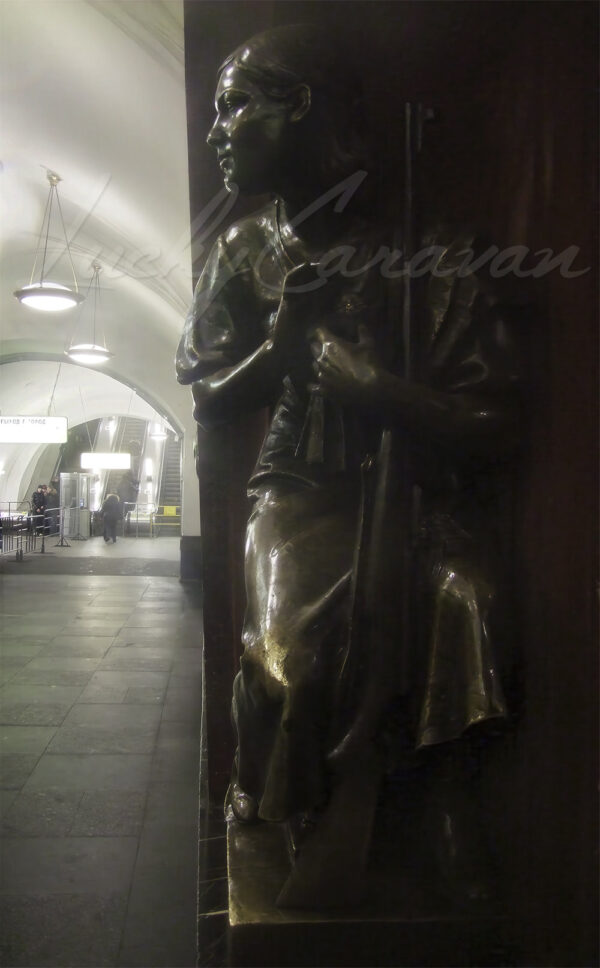 Bronze statue of a young girl with rifle in the Moscow metro, Russia.