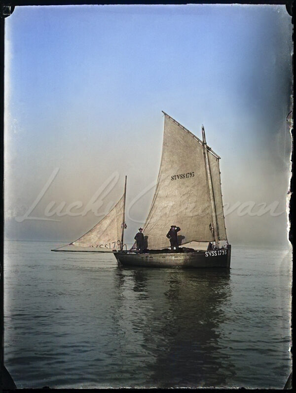 Traditional fishing boat and fishermen in Somme Bay, France, circa 1900.
