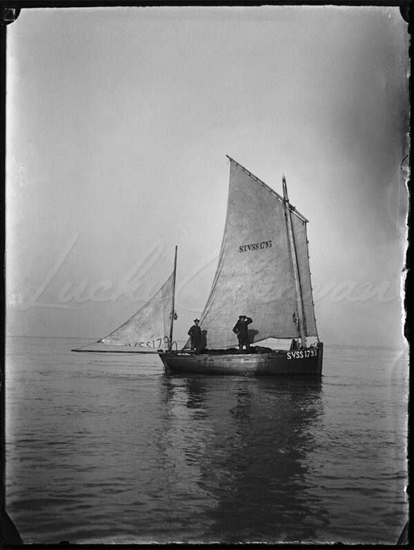 Traditional fishing boat and fishermen in Somme Bay, France, circa 1900