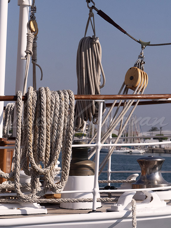 Ropes and wooden pulleys. Detail of the rigging on a traditional sailing ship.