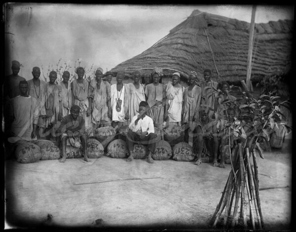 Preparing parcels in a village in the Guinean bush, Africa, circa 1900.