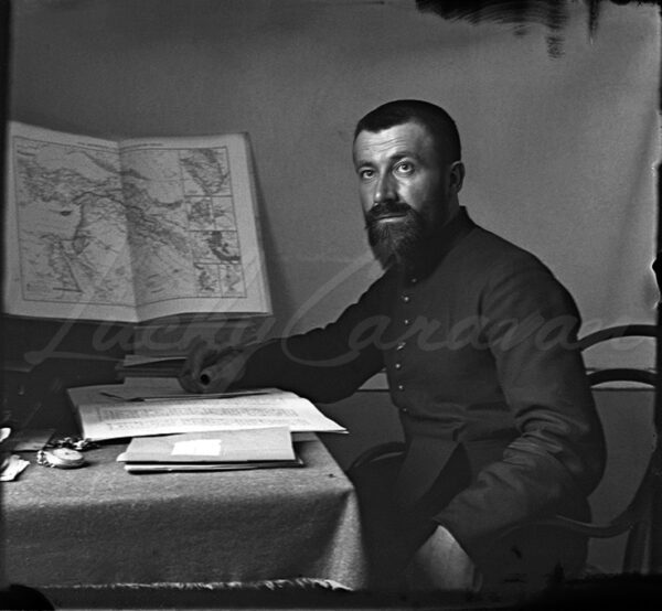 Palestine. A missionary priest standing in front of a map of the Middle East. 1920s